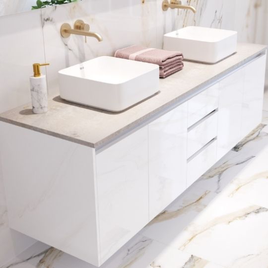 White finished vanity cabinet bathroom with golden fitted taps