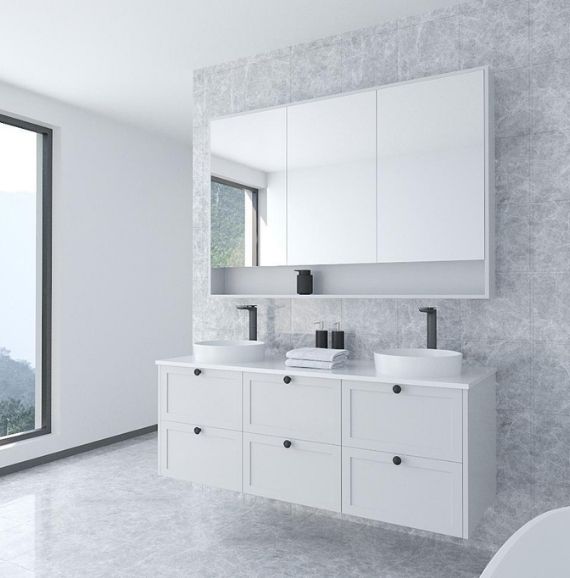 this is a white Mercury Mirror Cabinet in a gray marble bathroom with a large full wall mirror