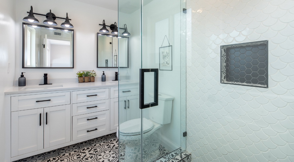 bright modern bathroom with 2 mirrors and vanity cabinets